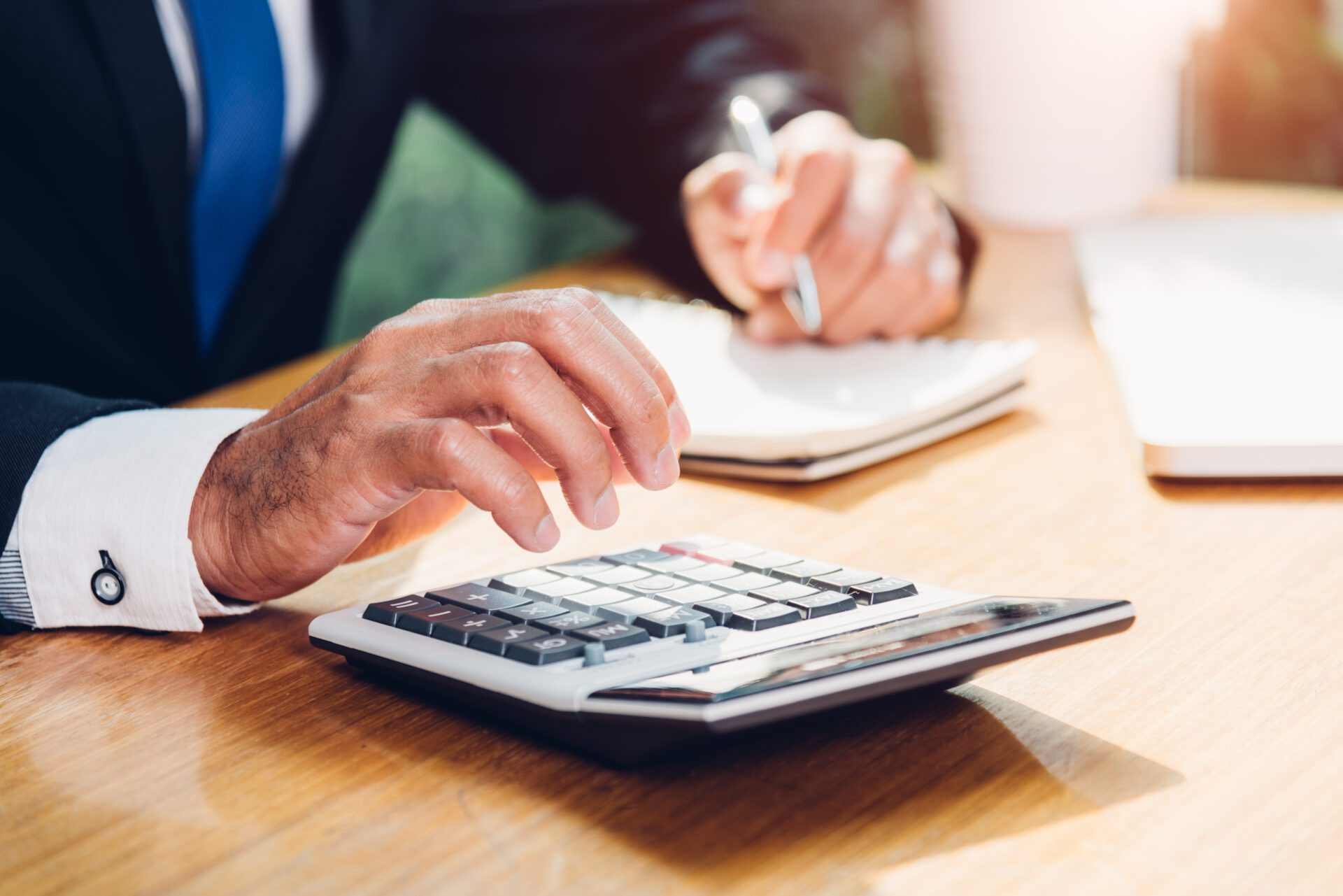 Business man accounting using calculating and work with laptop c Business man accounting using calculating and work with laptop computer on desk office, finance concept
