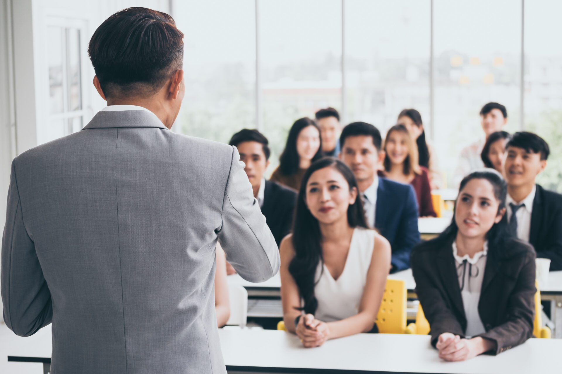 Businessman is explaining works to officers while training toget Businessman is explaining works to officers while training together at the office.